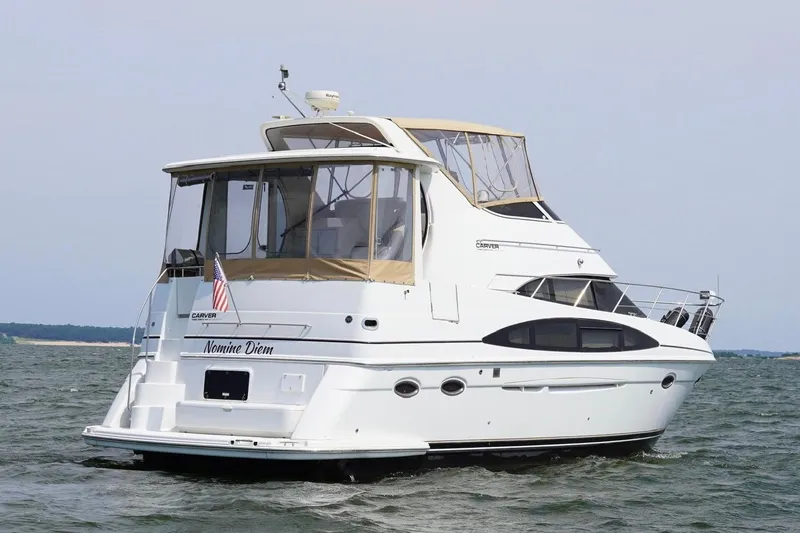 Slide: The Image of 2003 Carver 396 Motor Yacht cruising on open water, rear view. - 6