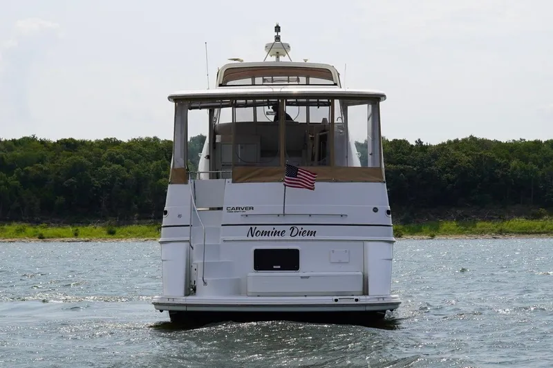 Slide: The Image of 2003 Carver 396 Motor Yacht on water, rear view with American flag. - 7