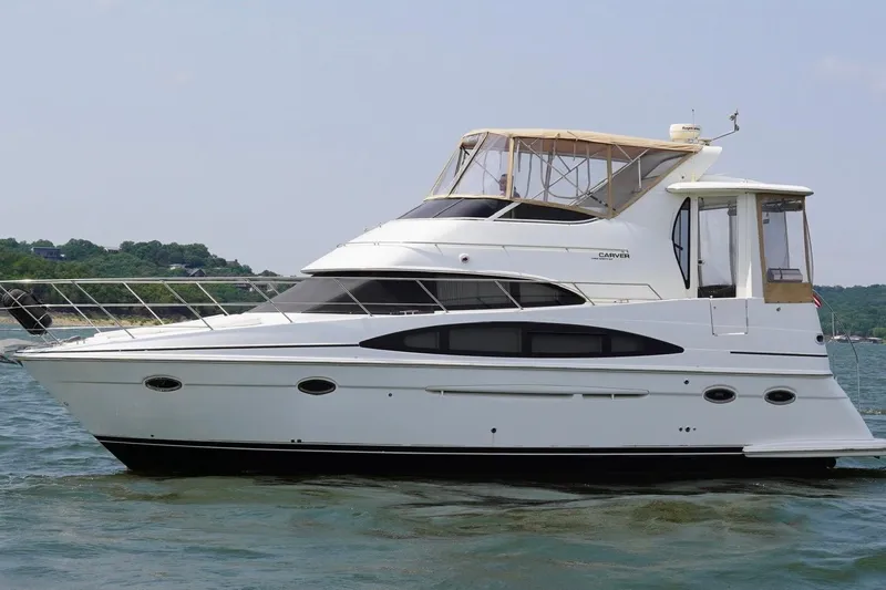 Slide: The Image of 2003 Carver 396 Motor Yacht on water, side view, with scenic background. - 9