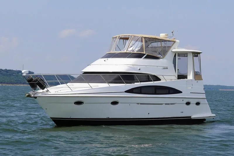 The Image of 2003 Carver 396 Motor Yacht cruising on open water under clear skies. - 0