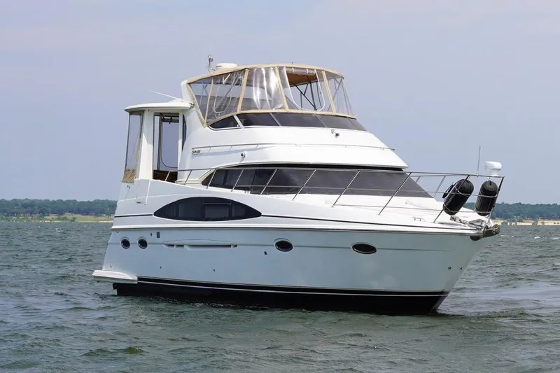 Slide: The Image of 2003 Carver 396 Motor Yacht cruising on open water, showcasing sleek design and luxury features. - 13