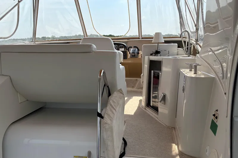 Slide: The Image of 2003 Carver 396 Motor Yacht interior with canopy, overlooking serene waters. - 19