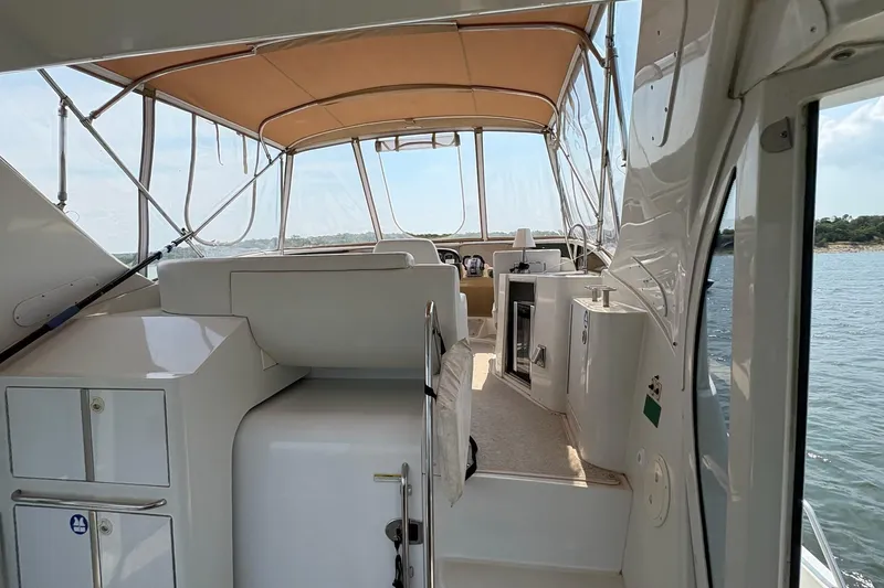 Slide: The Image of 2003 Carver 396 Motor Yacht interior with stairs, cabinets, and water view. - 20