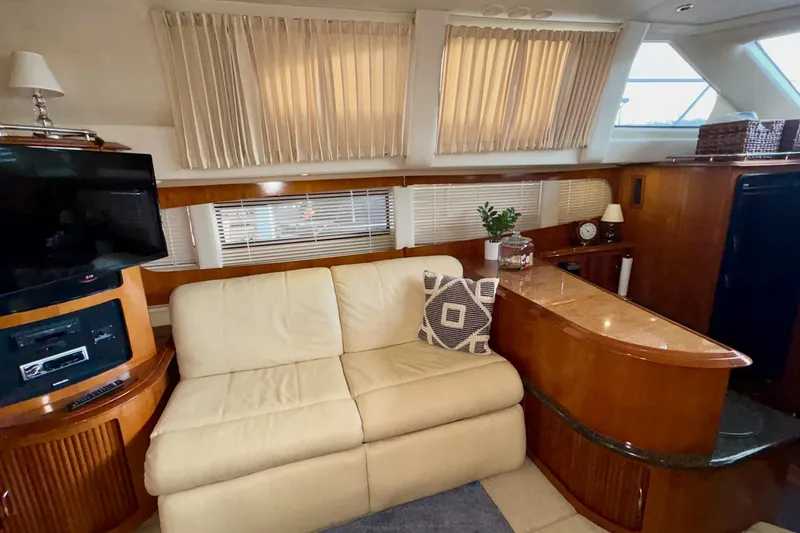 Slide: The Image of Luxurious interior of 2003 Carver 396 Motor Yacht with cream leather sofa and nautical decor. - 29