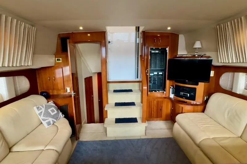 Slide: The Image of Luxurious interior of 2003 Carver 396 Motor Yacht with wood cabinetry and plush seating. - 33