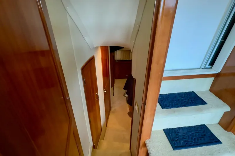 Slide: The Image of Luxurious bedroom interior of 2003 Carver 396 Motor Yacht with cozy bed and wooden cabinetry. - 35