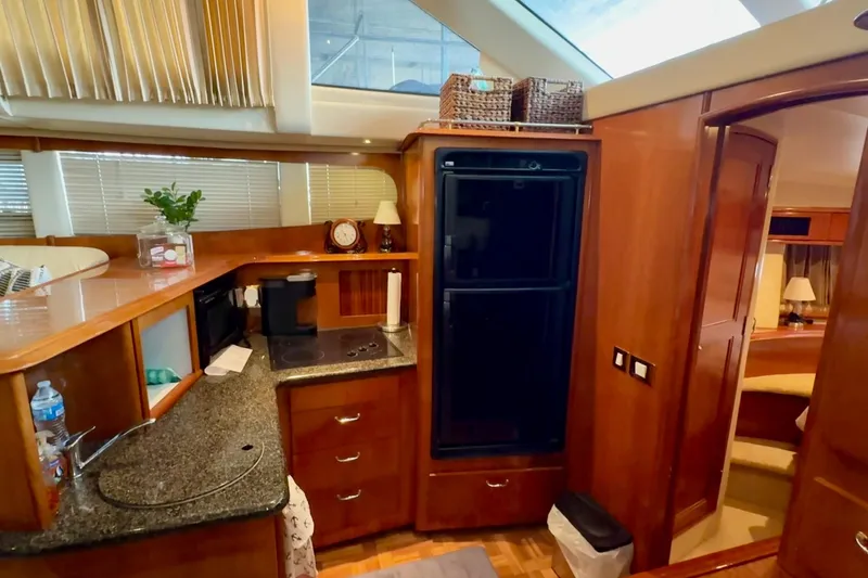Slide: The Image of 2003 Carver 396 Motor Yacht interior with wood cabinetry and cozy bedroom view. - 42