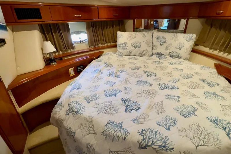Slide: The Image of Cozy bedroom in 2003 Carver 396 Motor Yacht with coral-patterned bedding. - 45