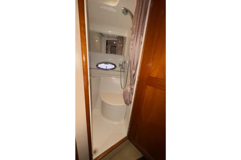 Slide: The Image of 2003 Carver 396 Motor Yacht bathroom with wood accents and porthole window. - 47