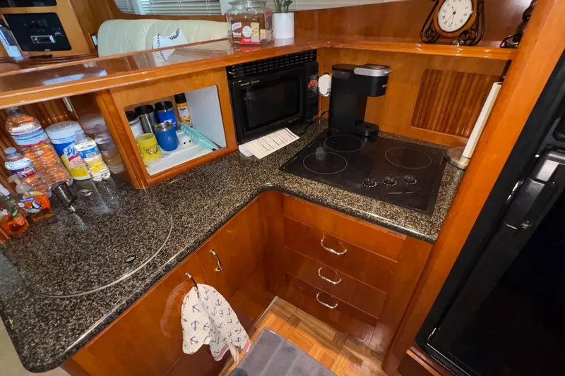 Slide: The Image of Engine compartment of a 2003 Carver 396 Motor Yacht, featuring mechanical components and wiring. - 50