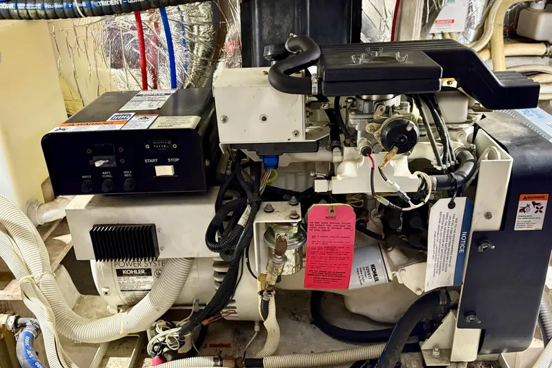 Slide: The Image of Engine room of a 2003 Carver 396 Motor Yacht, featuring a red engine and various components. - 52