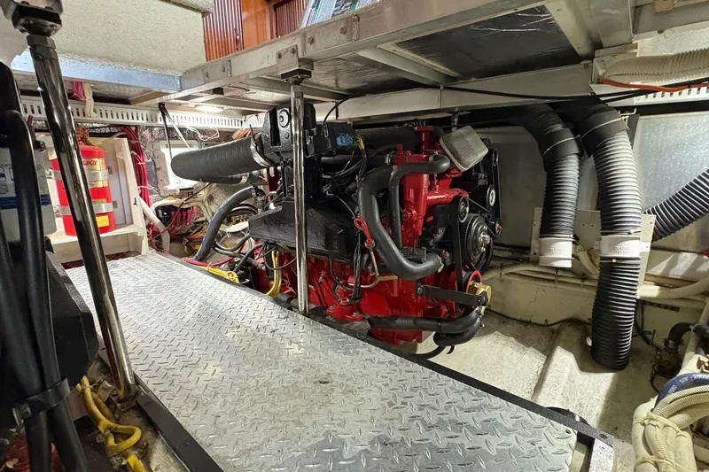 Slide: The Image of Engine room of 2003 Carver 396 Motor Yacht, featuring a red marine engine. - 53