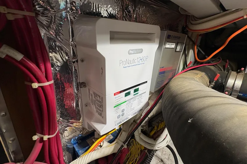 Slide: The Image of Engine compartment of a 2003 Carver 396 Motor Yacht with visible wiring and components. - 57