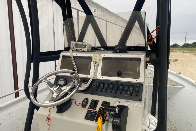 Slide: The Image of 2015 Blazer Bay 2400 boat console with steering wheel and control panel. - 5