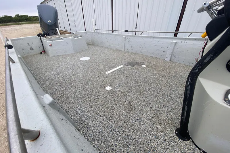 Slide: The Image of 2015 Blazer Bay 2400 boat interior with textured flooring and outboard motor. - 7