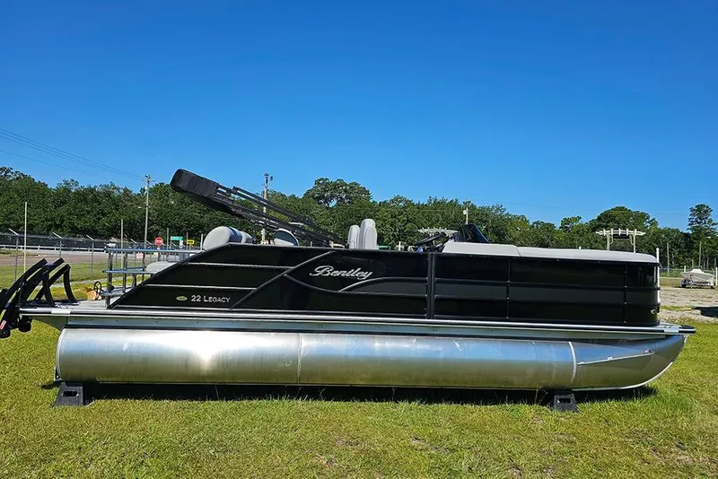 The Image of 2026 Bentley Pontoons Legacy 223 Quad Swing Back 3/4 Tritoon on grass under clear sky. - 1