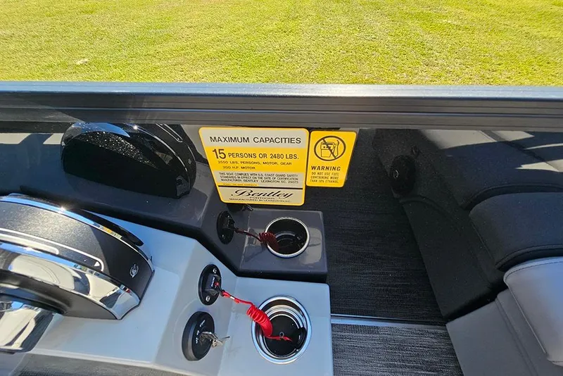 Slide: The Image of 2026 Bentley Pontoons Legacy 223 Tritoon dashboard with capacity warning label. - 21