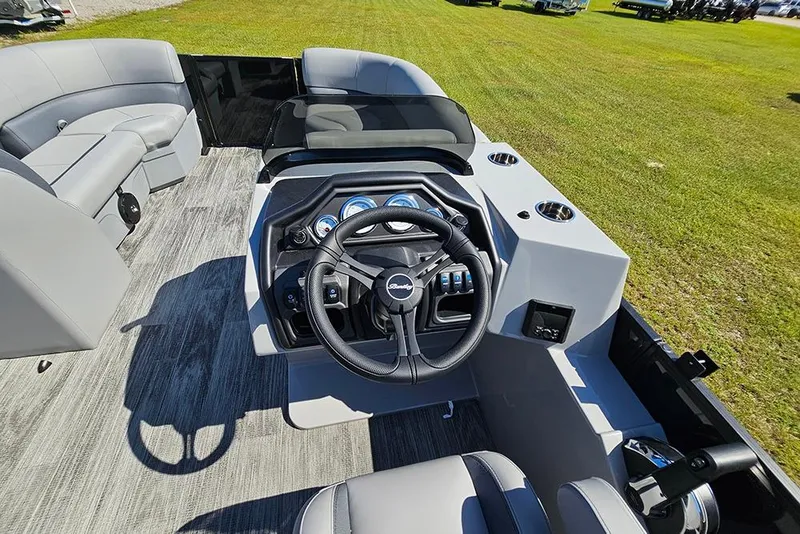 Slide: The Image of 2026 Bentley Pontoons Legacy 223 Tritoon helm with modern controls and seating. - 22