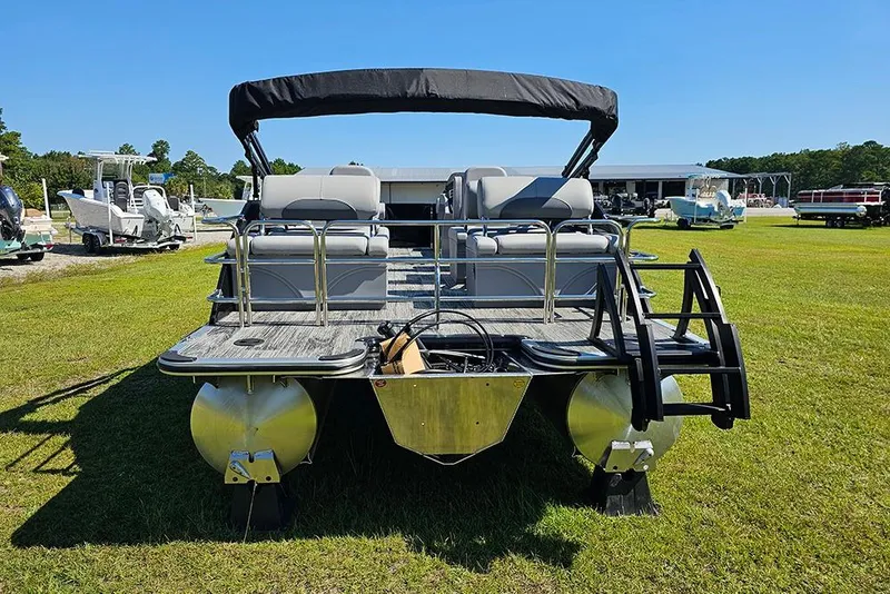 Slide: The Image of 2026 Bentley Pontoons Legacy 223 Quad Swing Back 3/4 Tritoon on grassy field. - 8
