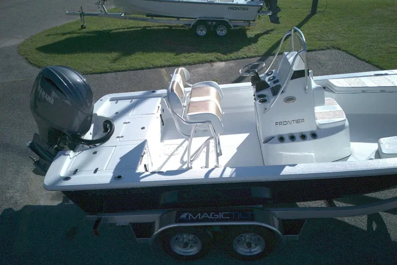 Slide: The Image of 2026 Frontier 2104 boat with Yamaha engine on Magic Tilt trailer, parked on pavement. - 5