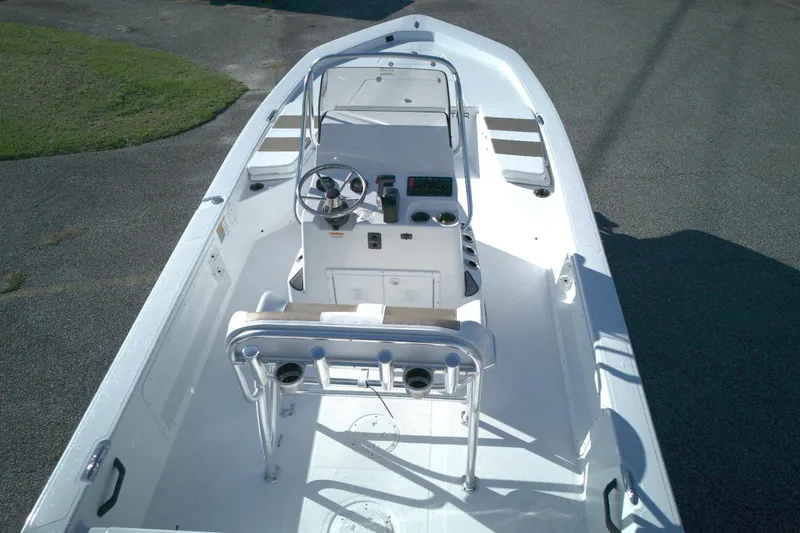 Slide: The Image of 2026 Frontier 2104 boat interior with steering console and seating, viewed from above. - 6