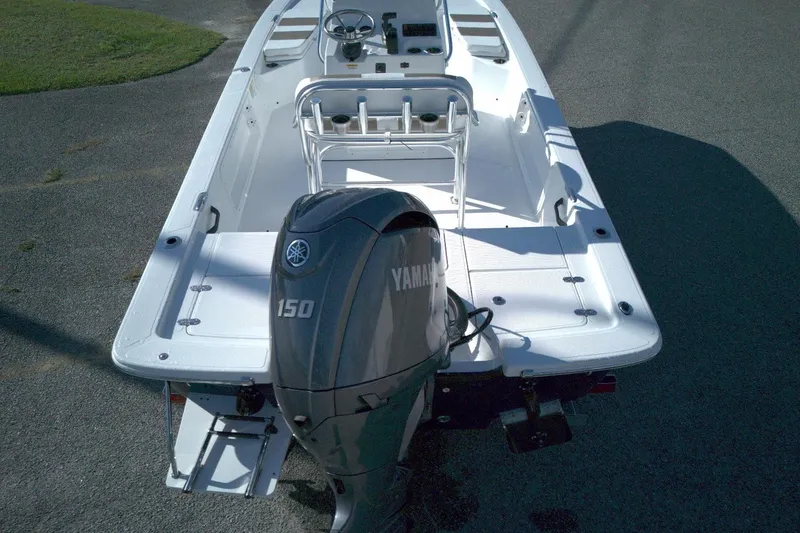 Slide: The Image of 2026 Frontier 2104 boat with Yamaha 150 engine, parked on asphalt. - 8
