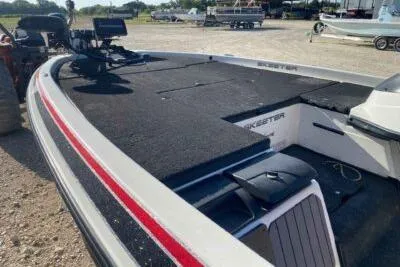 Slide: The Image of 2012 Skeeter FX20 boat with black deck and red accents, parked outdoors. - 9