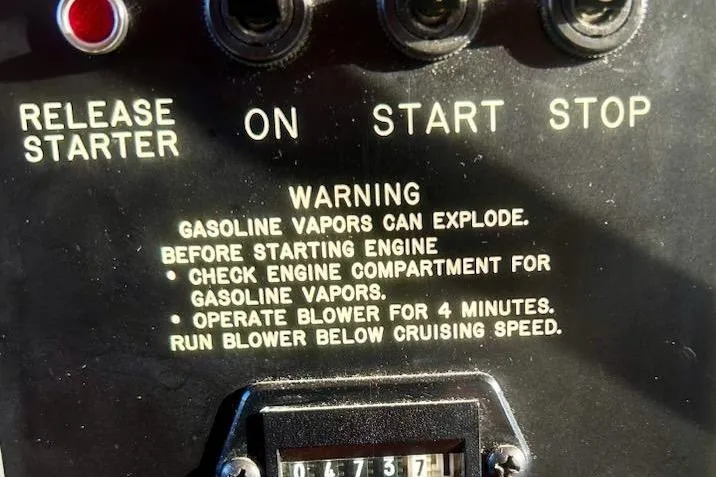Slide: The Image of Control panel of a 1996 Gibson 41 Classic Houseboat with safety warning instructions. - 14