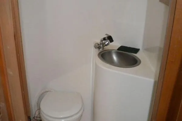 Slide: The Image of Compact bathroom in 1996 Gibson 41 Classic Houseboat with toilet and small sink. - 16