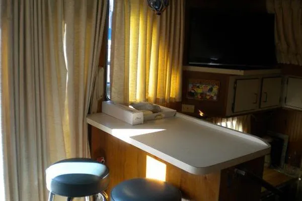 Slide: The Image of Interior of 1996 Gibson 41 Classic Houseboat with bar stools and curtains. - 21