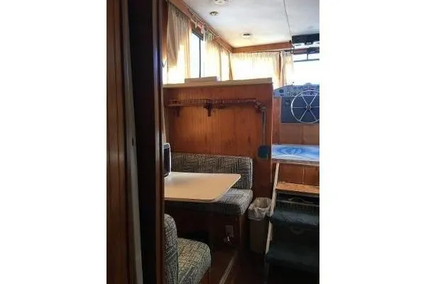 Slide: The Image of 1996 Gibson 41 Classic Houseboat interior with dining area and wooden paneling. - 26