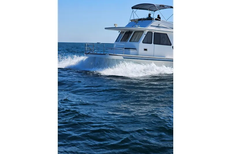 Slide: The Image of 1994 Gibson 41 Classic Houseboat cruising on open water. - 30