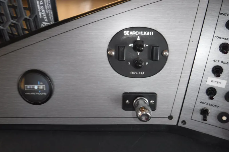 Slide: The Image of Control panel of a 1994 Gibson 41 Classic Houseboat with searchlight and engine hour gauge. - 33