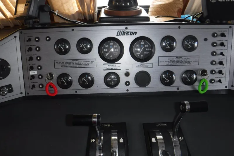 Slide: The Image of Control panel of a 1994 Gibson 41 Classic Houseboat with gauges and switches. - 36