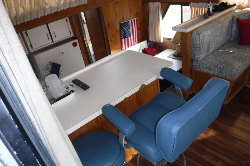 Slide: The Image of Interior of 1994 Gibson 41 Classic Houseboat with blue seating and American flag decor. - 40