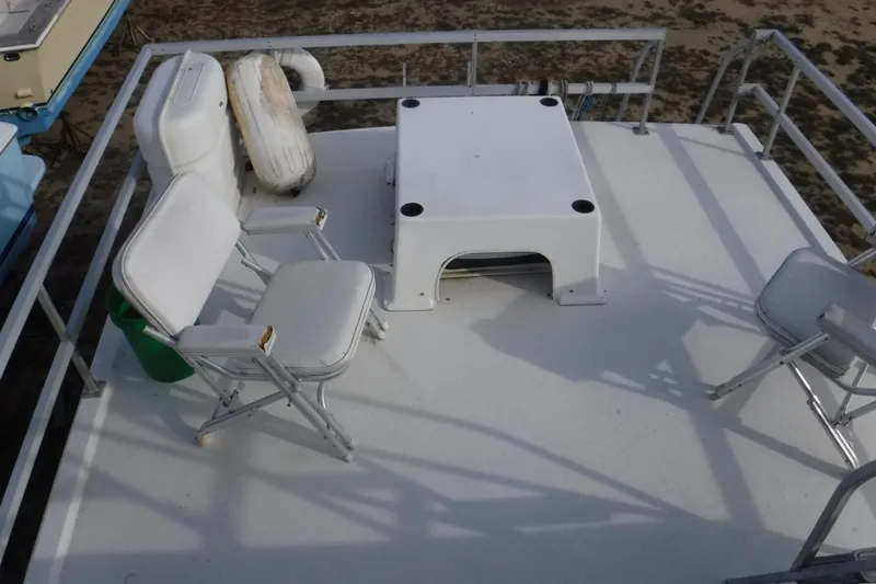 Slide: The Image of 1994 Gibson 41 Classic Houseboat deck with white chairs and table. - 41