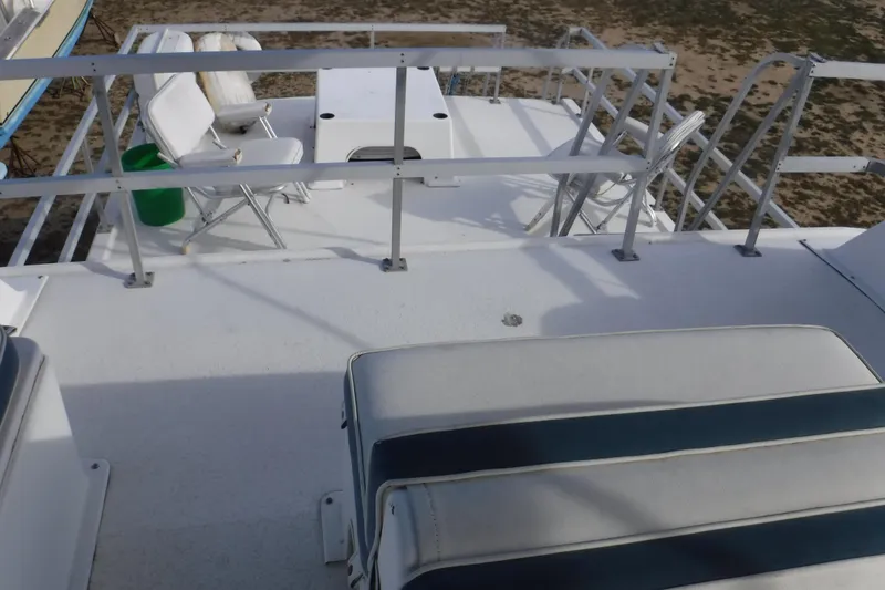 Slide: The Image of 1994 Gibson 41 Classic Houseboat deck with seating and railing, offering a spacious outdoor area. - 42
