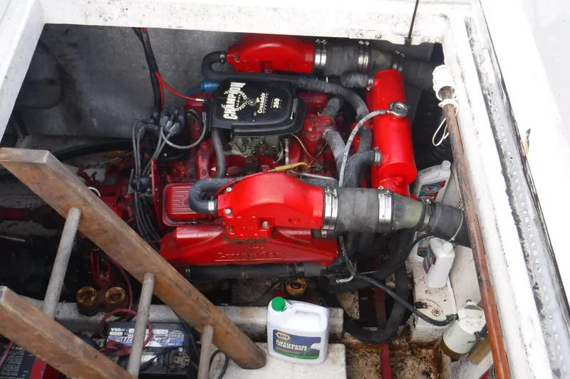 Slide: The Image of Engine compartment of a 1994 Gibson 41 Classic Houseboat, featuring a red engine and various components. - 52