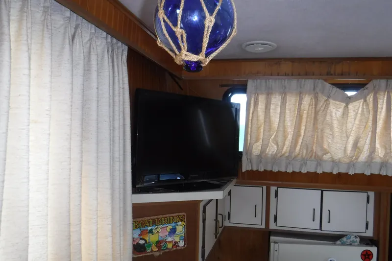 Slide: The Image of Interior of 1994 Gibson 41 Classic Houseboat with TV, cabinets, and nautical decor. - 54
