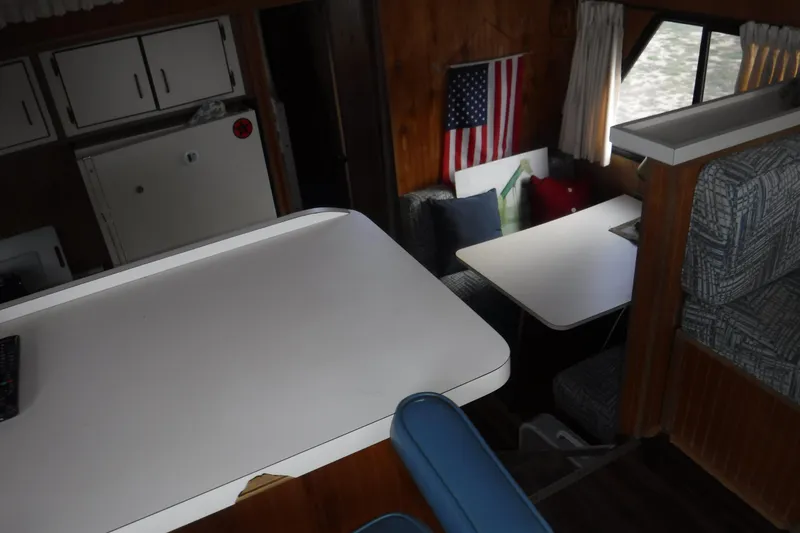 Slide: The Image of Interior of 1994 Gibson 41 Classic Houseboat with dining area and American flag decor. - 55