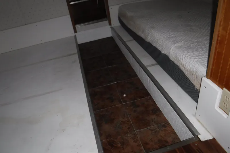 Slide: The Image of Interior of 1994 Gibson 41 Classic Houseboat showing bed and flooring details. - 57