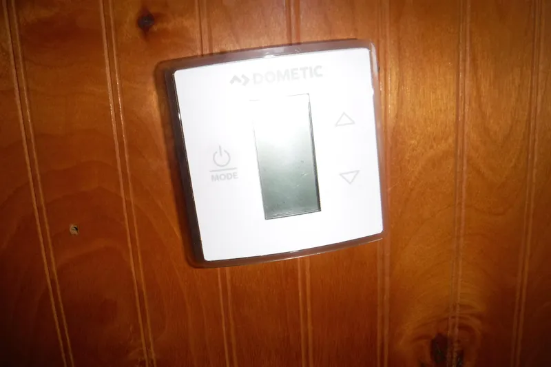 Slide: The Image of Dometic thermostat on wooden panel of 1994 Gibson 41 Classic Houseboat. - 61