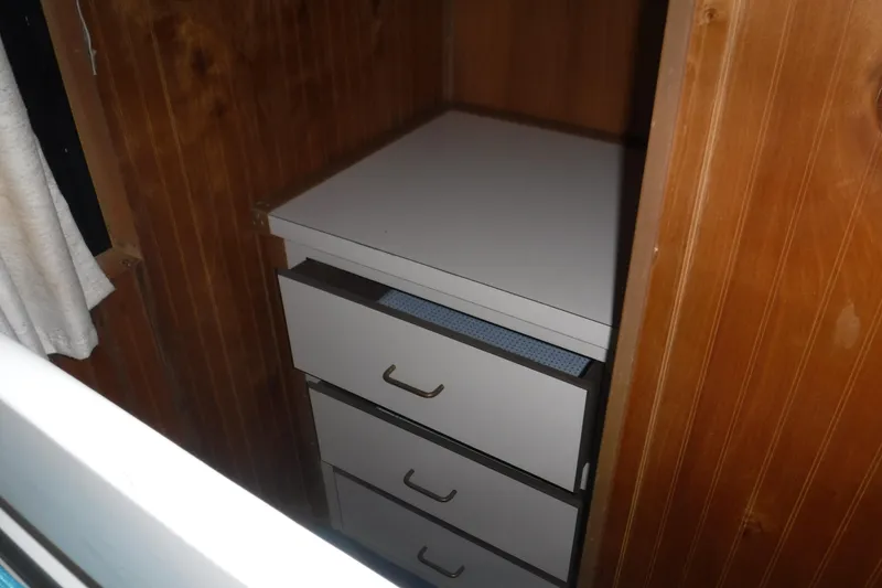 Slide: The Image of White drawers inside a wooden cabin of a 1994 Gibson 41 Classic Houseboat. - 62