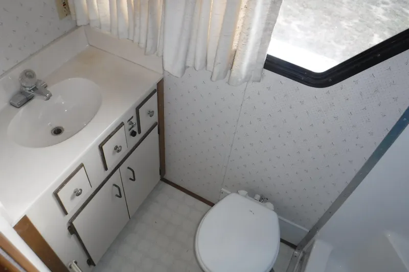 Slide: The Image of Bathroom interior of 1994 Gibson 41 Classic Houseboat with sink, toilet, and window. - 65