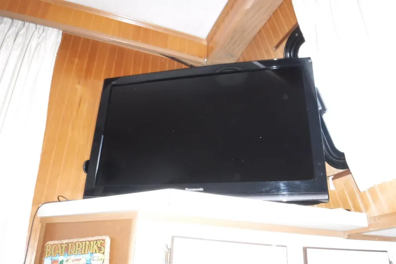 Slide: The Image of Panasonic TV mounted in 1994 Gibson 41 Classic Houseboat interior with wood paneling. - 66
