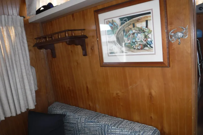 Slide: The Image of Interior of 1994 Gibson 41 Classic Houseboat with wood paneling and framed artwork. - 68