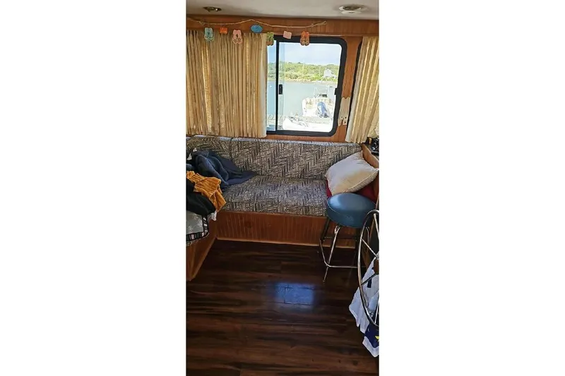 Slide: The Image of Interior of 1996 Gibson 41 Classic Houseboat with cozy seating and window view. - 8