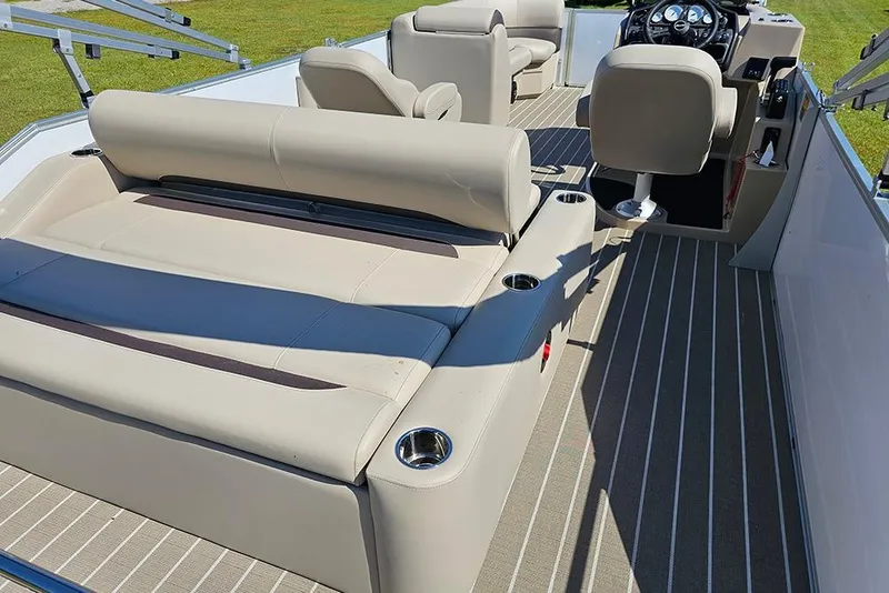 Slide: The Image of 2026 Bentley Pontoons 243 Legacy Swingback on grass, showcasing rear view and ladder. - 10