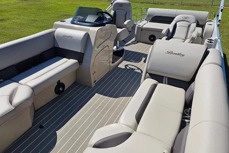 Slide: The Image of 2026 Bentley Pontoons 243 Legacy Swingback with ladder on grassy field. - 11