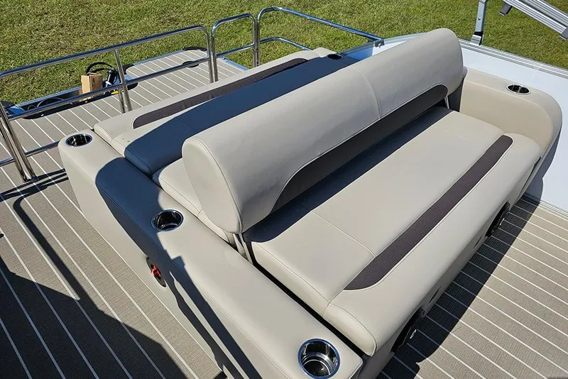 Slide: The Image of 2026 Bentley Pontoons 243 Legacy Swingback interior with beige seating and striped flooring. - 12